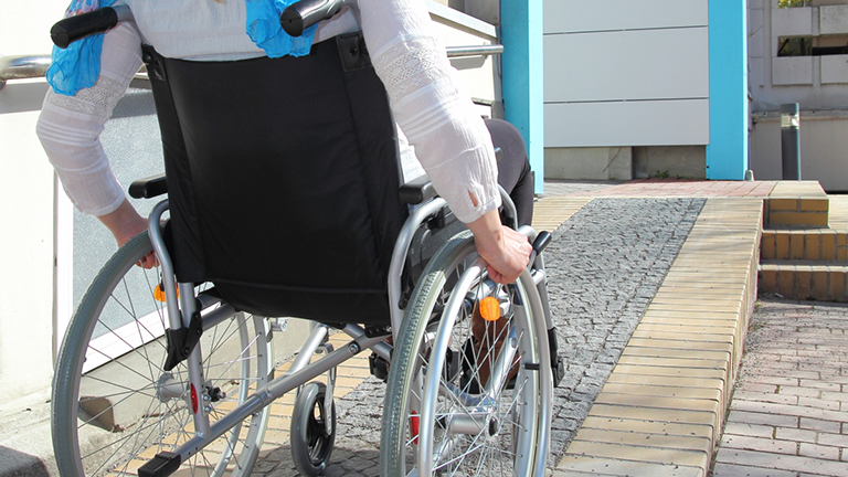 A person using a wheelchair ramp