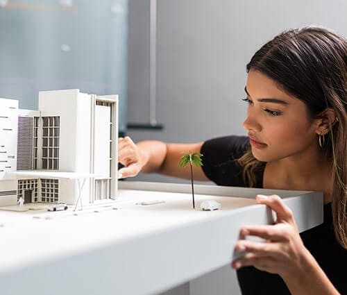 Architect Studying Building Layout Scale Model