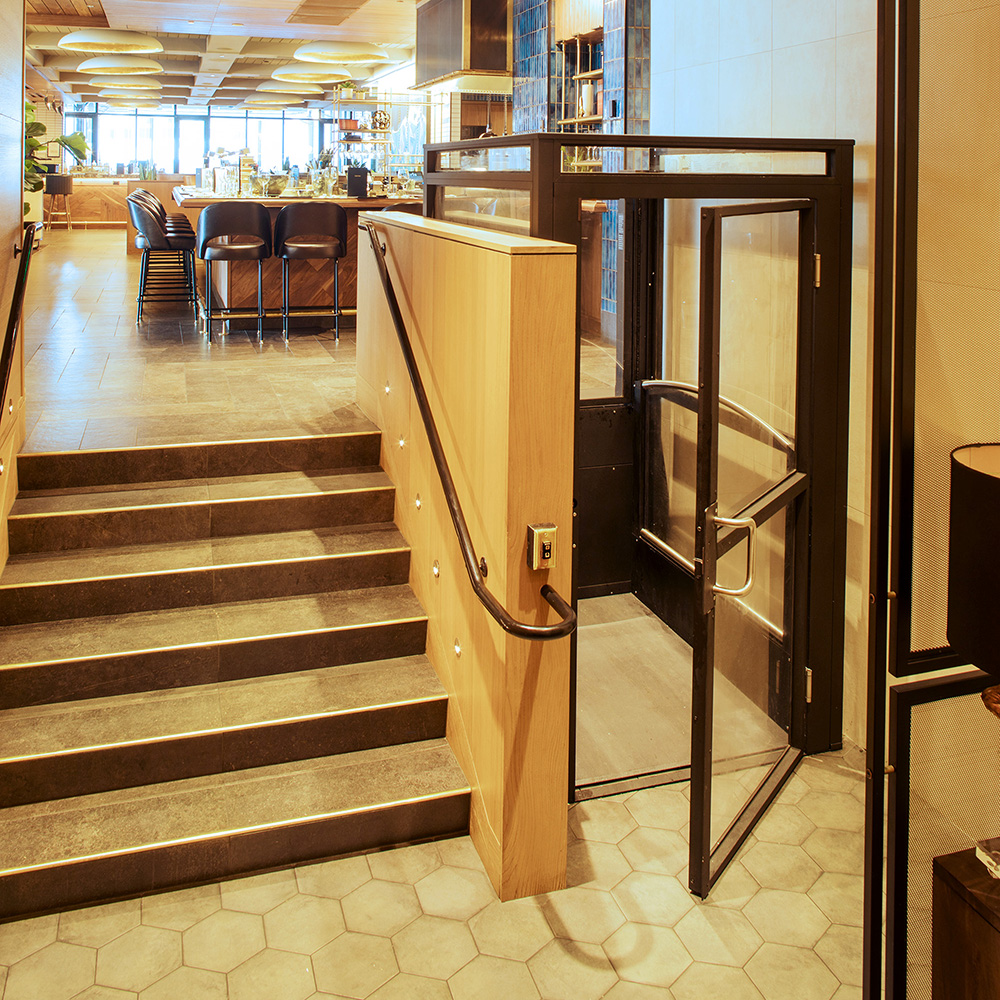 An Ascension Lift wheelchair lift is seen inside an Earls Restaurant